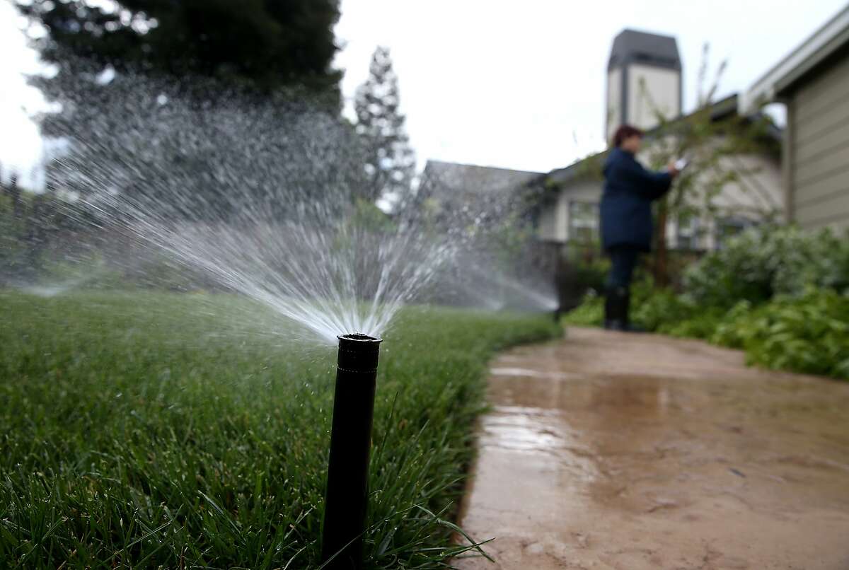 East Bay Municipal Utility District (EBMUD) water conservation technician Rachel Garza inspects a sprinkler system as she performs a water conservation audit of a home on April 7, 2015 in Walnut Creek, California. As California enters its fourth year of severe drought, EBMUD and water districts throughout the state are assisting customers with finding ways to reduce water use at their homes. California residents are facing a mandatory 25 percent reduction in water use. (Photo by Justin Sullivan/Getty Images)