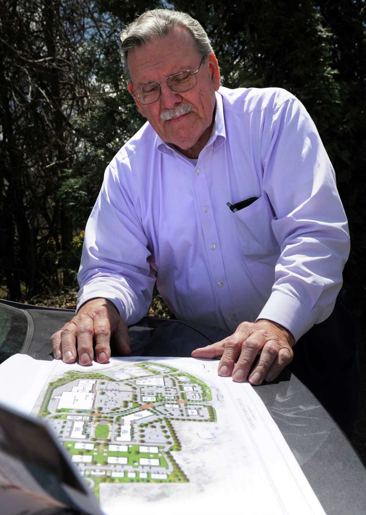 Herman Schuler, sales and development consultant for Haynes, goes over the plans for Oxford's future mixed use development that will include 150 homes and a Market 32, formerly Price Chopper supermarket, Tuesday, April 28, 2015, at the site off of Route 67 in Oxford, Conn.