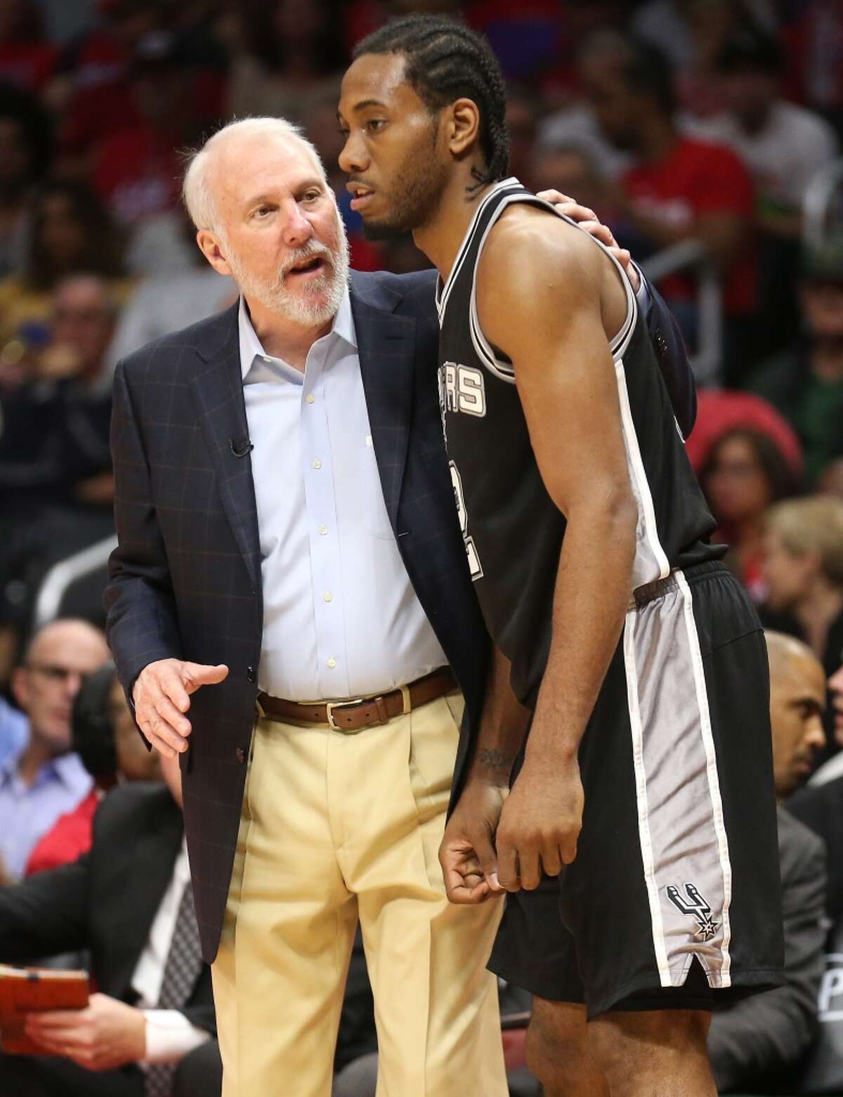 LOS ANGELES, CA - APRIL 28: Head coach Gregg Popovich and Kawhi Leonard #2 of the San Antonio Spurs confer as they play the Los Angeles Clippers during Game Five of the Western Conference quarterfinals of the 2015 NBA Playoffs at Staples Center on April 28, 2015 in Los Angeles, California. The Spurs won 111-107. NOTE TO USER: User expressly acknowledges and agrees that, by downloading and or using this photograph, User is consenting to the terms and conditions of the Getty Images License Agreement. (Photo by Stephen Dunn/Getty Images)