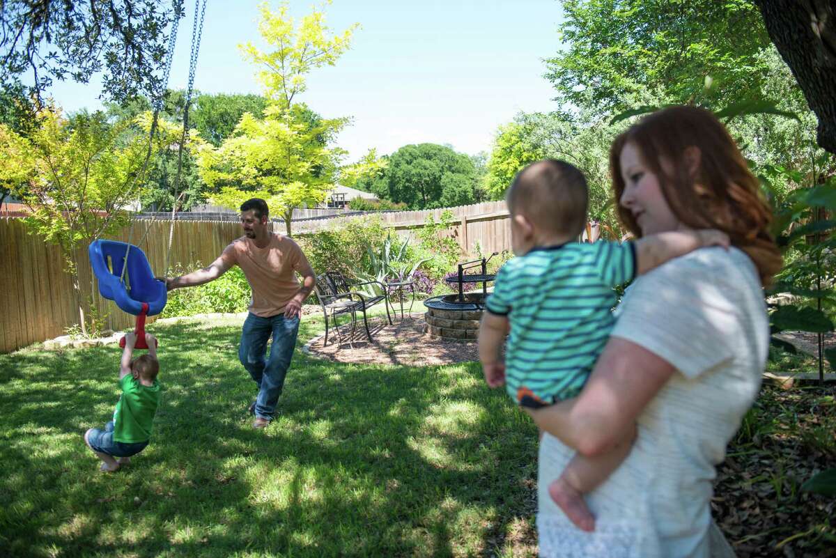 Clint Martin pushes his son Case on a swing as Lindsay Martin holds the couple's second son Ridge at the Martin's house in New Braunfels, Texas on Wednesday April 29, 2015. Lindsay and Clint Martin's two sons Case, 3, and Ridge, 6 months, both have Severe Combined Immunodeficiency or SCID, a disease that leaves them with a severely restricted immune system to combat infections and other ailments. When Case had problems breathing a few months after being born, the Martins scrambled to find a diagnosis. After Case was diagnosed with SCID (Lindsay Martin is a carrier) he underwent an umbilical cord blood transplant (the umbical cord was not his own, but from an individual in an anonymous pool of donors) and began to recover. Now he undergoes testing every year to determine if his health continues. Now the Martins are repeating the process with their second son, Ridge. They just returned to their home in New Braunfels after spending two months taking Ridge in and out of Texas Children's Hospital in Houston. "If not for people donating [umbilical} blood he would have died," Clint said, "[We're] thankful science and technology are where they are."