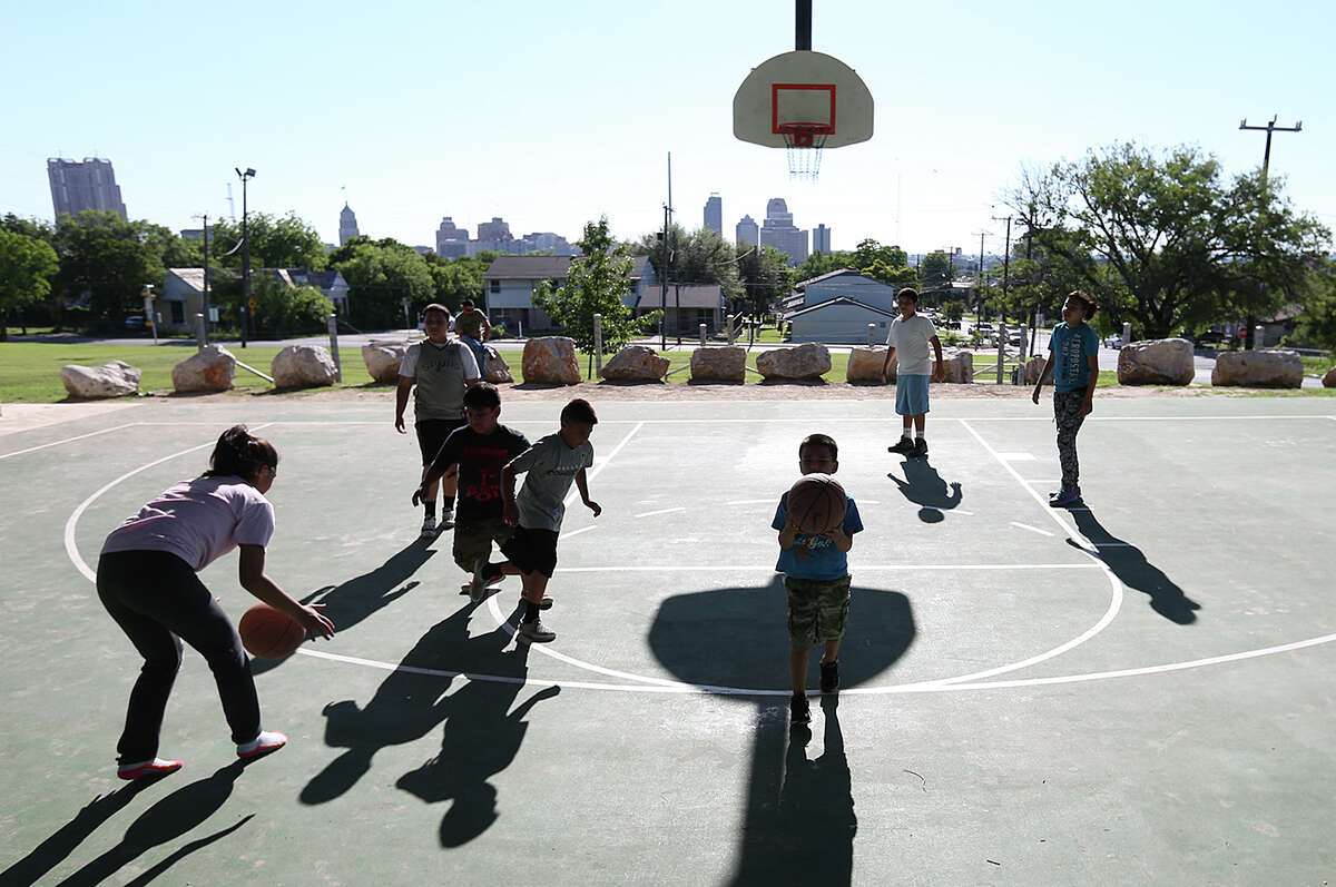 Boys and girls play basketball at Lockwood Park in the Dignowity Historical District, Wednesday, April 29, 2015. The neighborhood is undergoing gentrification. The San Antonio City Council got a list of recommendations on how to address gentrification during a B session meeting Wednesday.