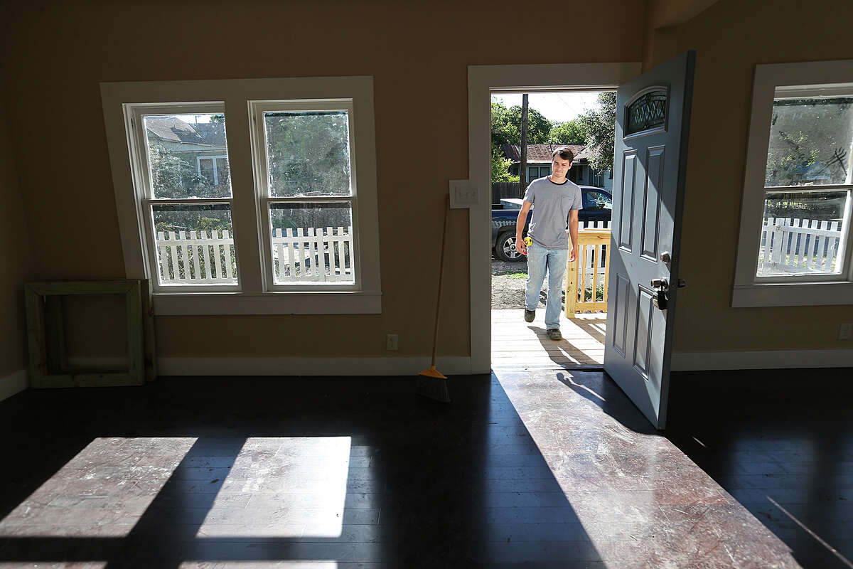Caleb Macias works on renovating a house at 306 Willow in the Dignowity Historical District, Wednesday, April 29, 2015. Macias bought the house in last August and hope to sell it once work is done. The neighborhood is undergoing gentrification. The San Antonio City Council got a list of recommendations on how to address gentrification during a B session meeting Wednesday.