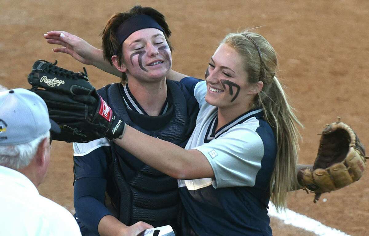 Smithson Valley pitcher Regan Mergele (right) embraces catcher Katherine Matthys after getting out of a third-inning jam against Churchill in their Class 6A bidistrict playoff matchup at the SAISD Complex.
