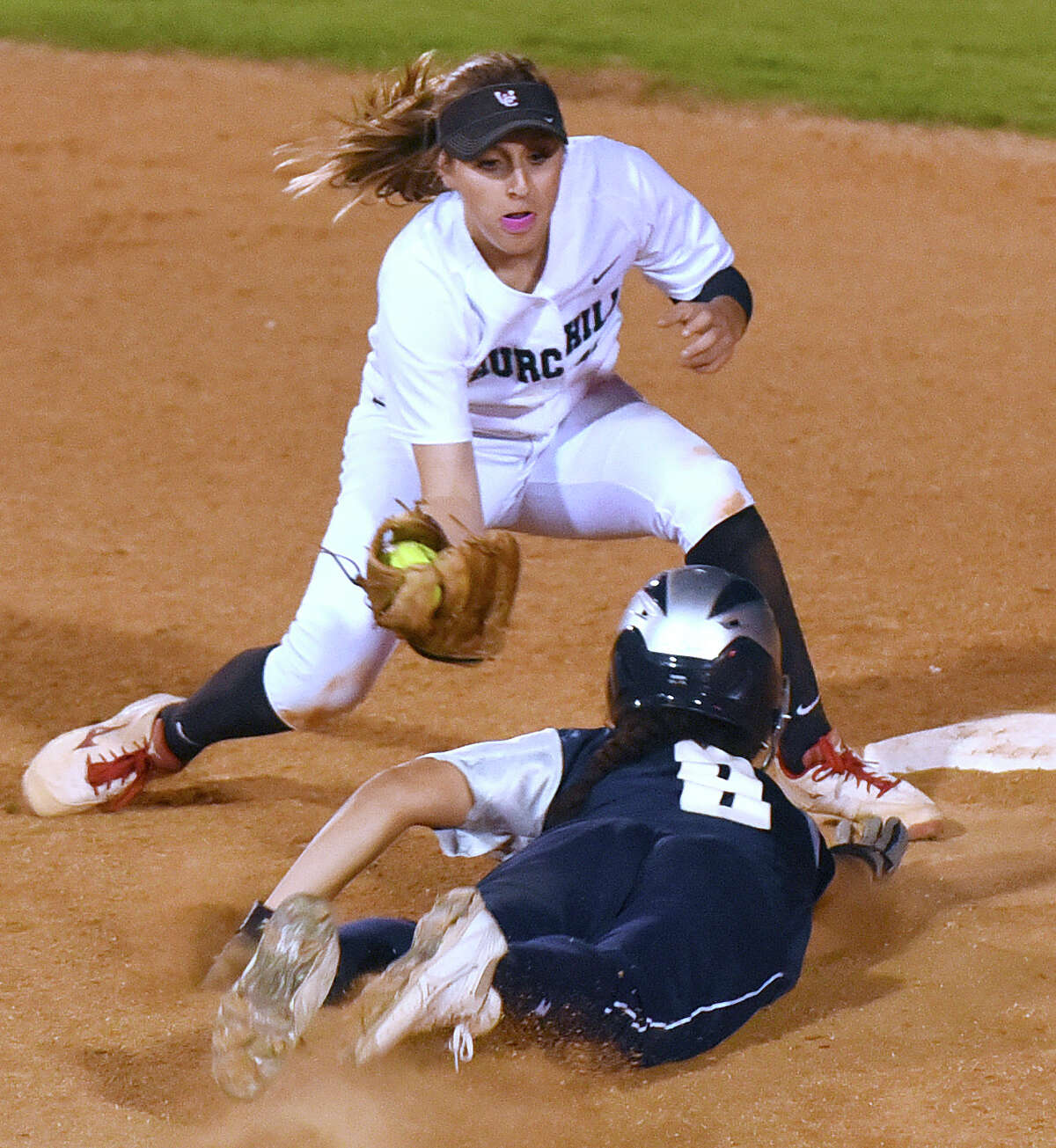 Churchill shortstop Abby White tags out Monique McElroy of Smithson Valley as she attempts to steal second base during UIL Class 6A first-round high school playoffs action at the SAISD complex on Wednesday, April 29, 2015.