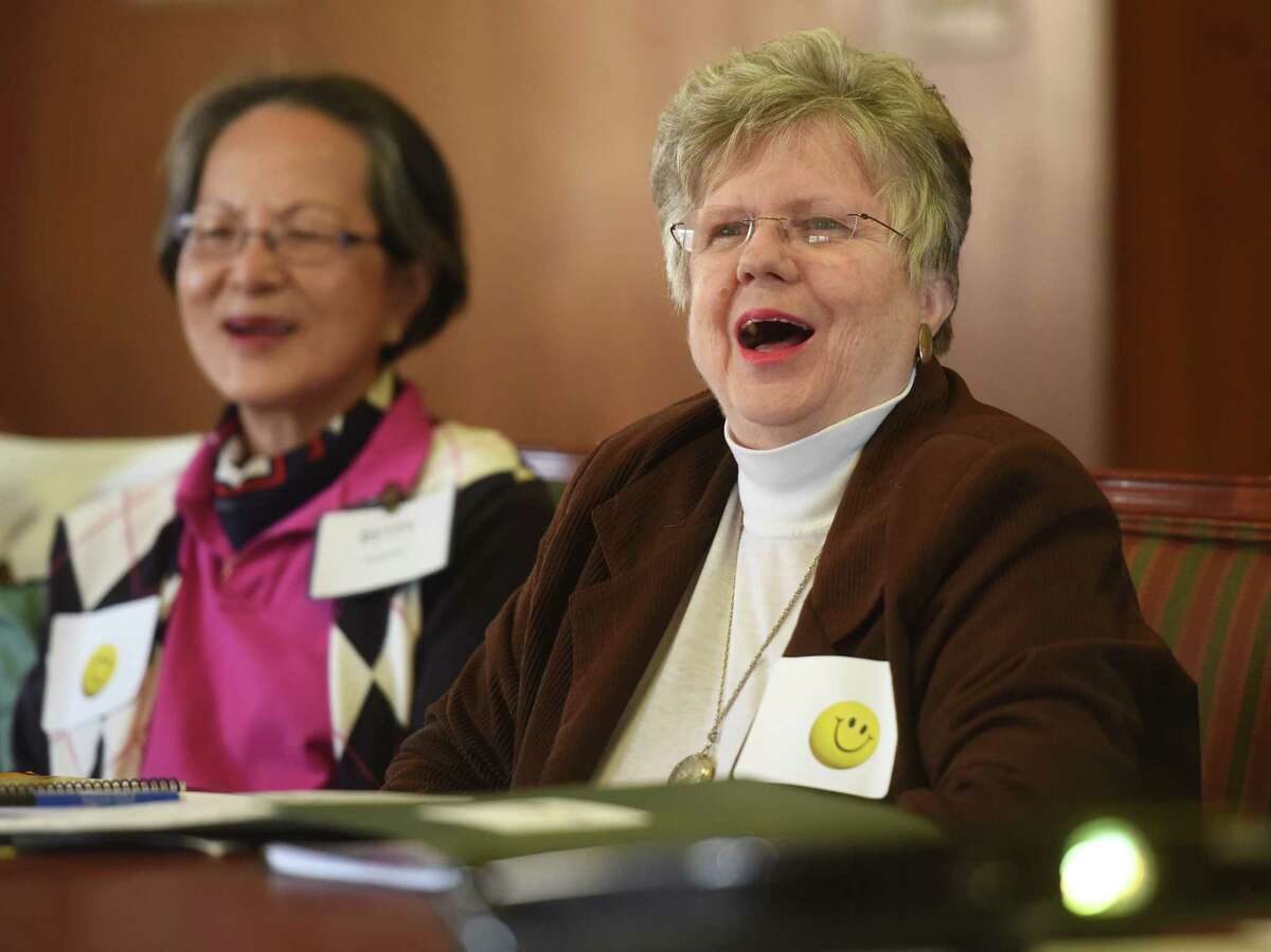 Greenwich residents Betty Courtney, left, and Shirley Mc Hugh laugh while participating in laughing exercise during the Super Noggin brain game at the Greenwich Senior Center in Greenwich, Conn. Thursday, April 30, 2015. Super Noggin is a comprehensive program teaching brain-healthy habits and tracking individual progress through a variety of fun physical and mental activities. The 11-week class costs $20 and takes place at the Greenwich Senior Center on Thursdays and Greenwich Library on Fridays.