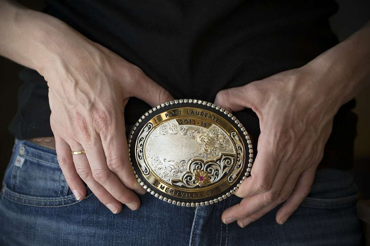 Sarah Kobrinsky wears a belt buckle with her accolade as the Poet Laureate of Emeryville. She was pushed out of Emeryville after the landlord raised her rent. She is photographed at store run by her and her husband, Jered's Pottery, in Berkeley, Calif. on Thursday, April 30, 2015.