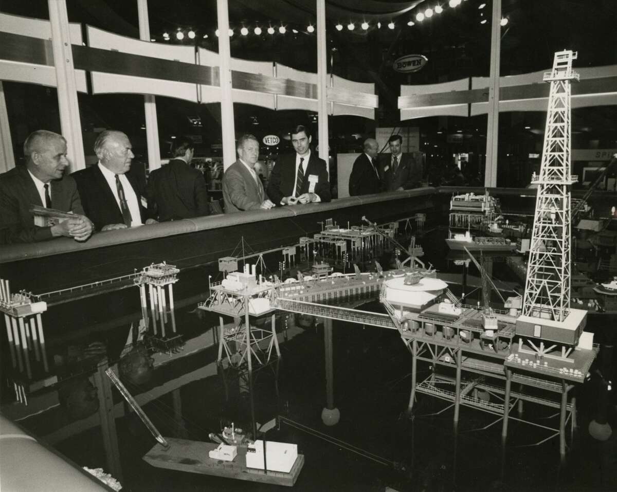 1971 - Attendees at the third annual Offshore Technology Conference gathered around an elaborate display of miniature marine drilling platforms, process facilities and derrick barges in the Halliburton exhibit. The three-day conference, was held in the Astrohall, attracting about 5,000 registrants on opening day.
