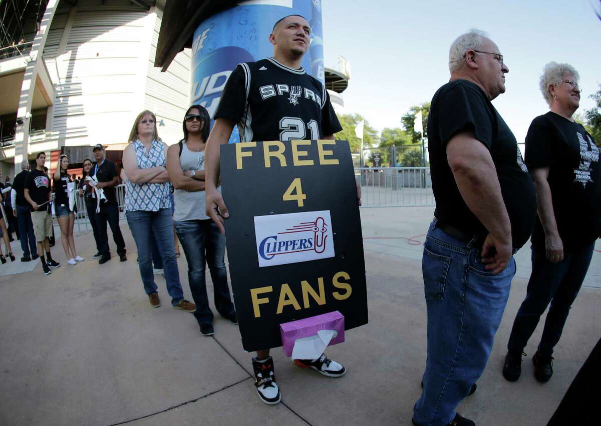 Spurs fan Juan Ramirez carries a message for Los Angeles Clippers supporters before Game 6 between the Spurs and the Clippers in the first round of the Western Conference playoffs at the AT&T Center on Thursday, Apr. 30, 2015.