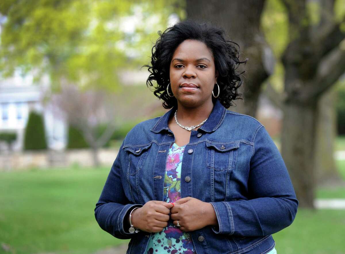 Merisa Williams, 34, of Bridgeport, Conn., is photographed in Danbury Friday, May 1, 2015, where she works at Western Connecticut State University. Williams was laid off by Gov. John Rowland in 2003 and is one of thousands of state employees who will share in a multi-million dollar settlement.