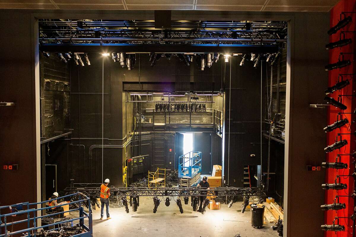 Constructions crews work to finish the new American Conservatory Theater which officially opens on May 14 on Market Street in San Francisco, Thursday, April 30, 2015. Here crews work to hang stage lighting.