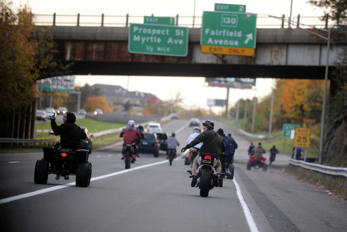 Dozens of riders on ATVs, dirtbikes and street bikes wreaked havoc across Bridgeport Saturday, Nov. 8, 2014 while evading cops and speeding through city streets. City officials are counting on tougher local laws and steeper fines to help police crack down on what has become a summertime hazard in Bridgeport and other urban areas where private or public land set aside for riding is scarce to nonexistent.