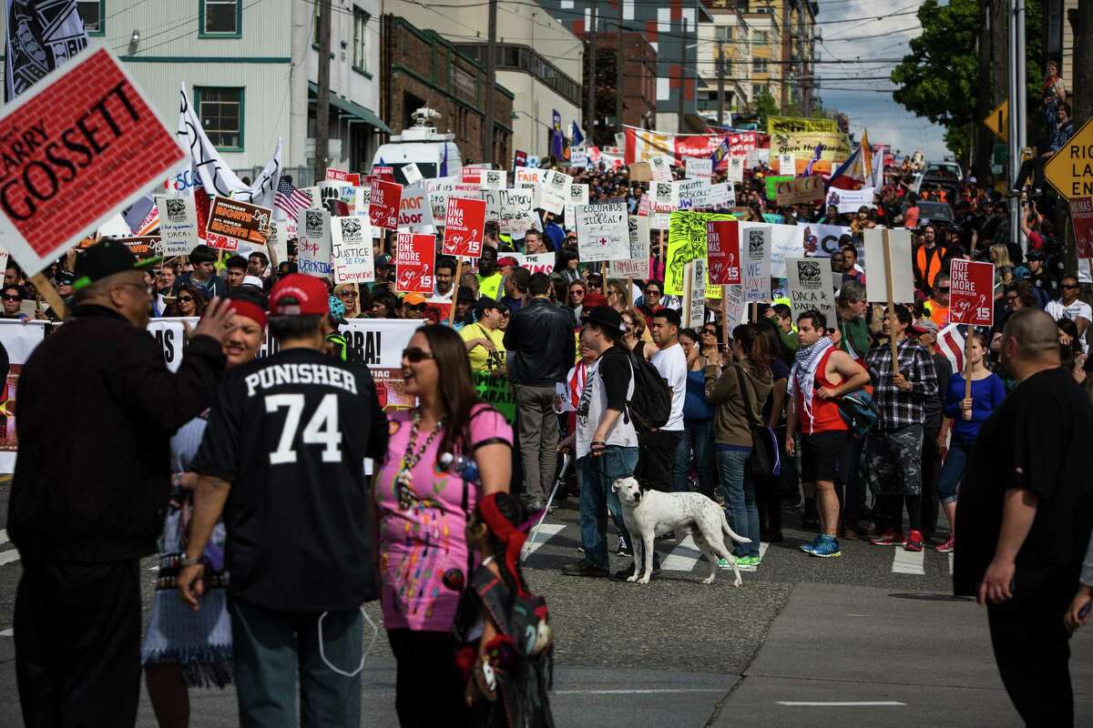 Protesters march together on Friday, May 1, 2015.