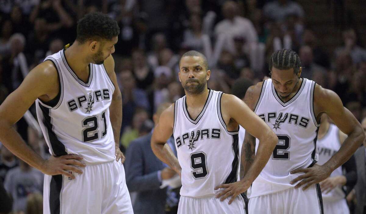 San Antonio Spurs' Tim Duncan (21), Tony Parker (9), and Kawhi Leonard (2) wait for play to resume during the second half of Game 6 in an NBA basketball first-round playoff series against the Los Angeles Clippers, Thursday, April 30, 2015, in San Antonio. Los Angeles won 102-96. (AP Photo/Darren Abate)