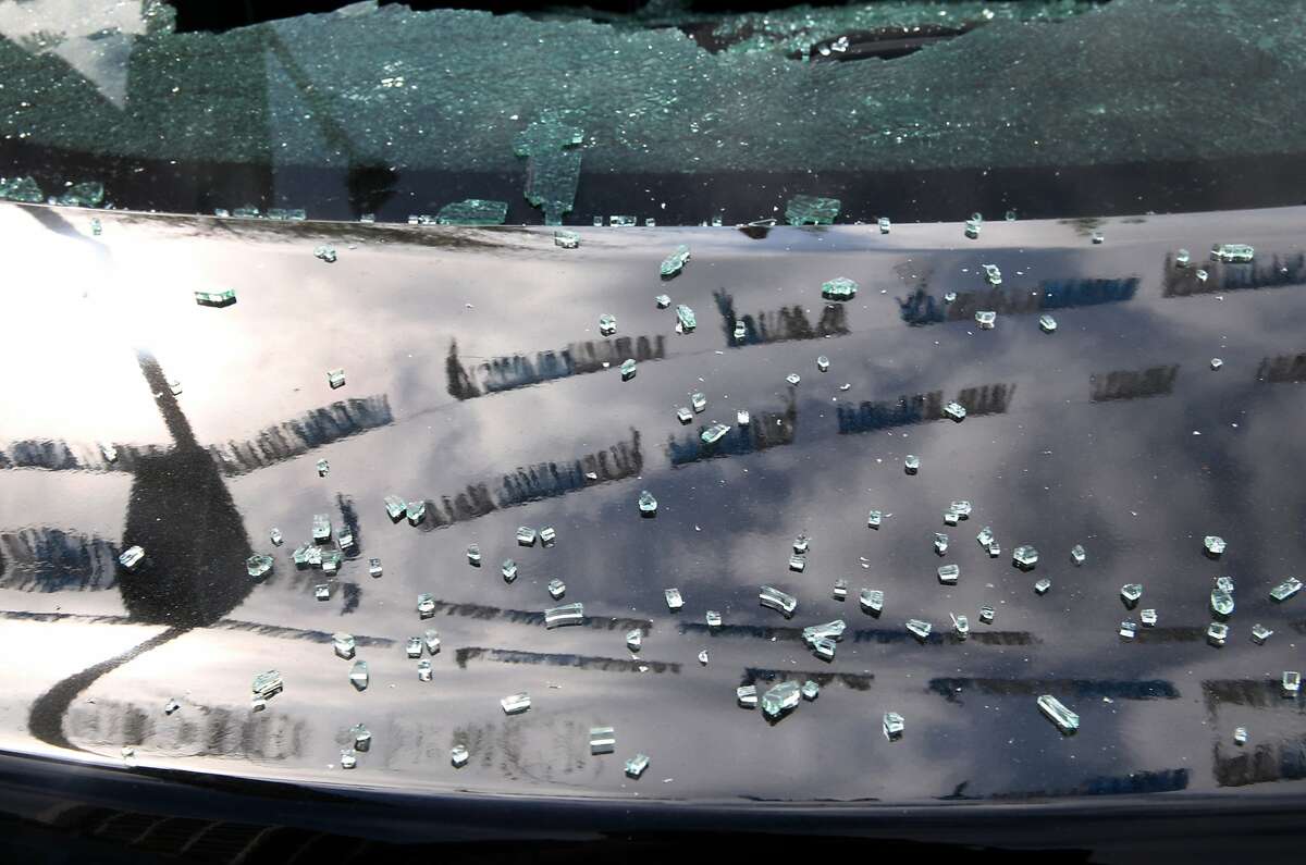 Shards of broken glass from a smashed rear window remain on the trunk of a new Hyundai sedan in Oakland, Calif. on Saturday, May 2, 2015 after a demonstration turned violent Friday night. More than 40 new cars parked in a dealership storage lot were heavily damaged or destroyed and windows were smashed at several businesses along the Broadway corridor.