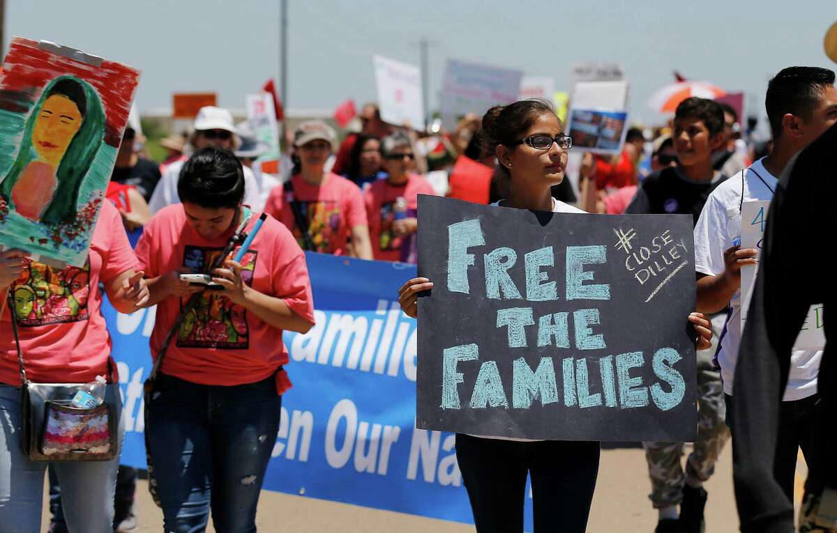 Hundreds march toward the immigrant detention center during march and protest in Dilley, Texas on Saturday, May 2, 2015.