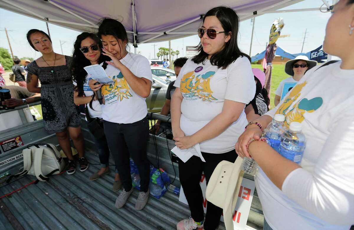 Marta Mejia (center) becomes emotional as she makes her plea to free the immigrants in the detention center in Dilley during a march and protest with hundreds of supporters on Saturday, May 2, 2015. (Kin Man Hui/San Antonio Express-News)