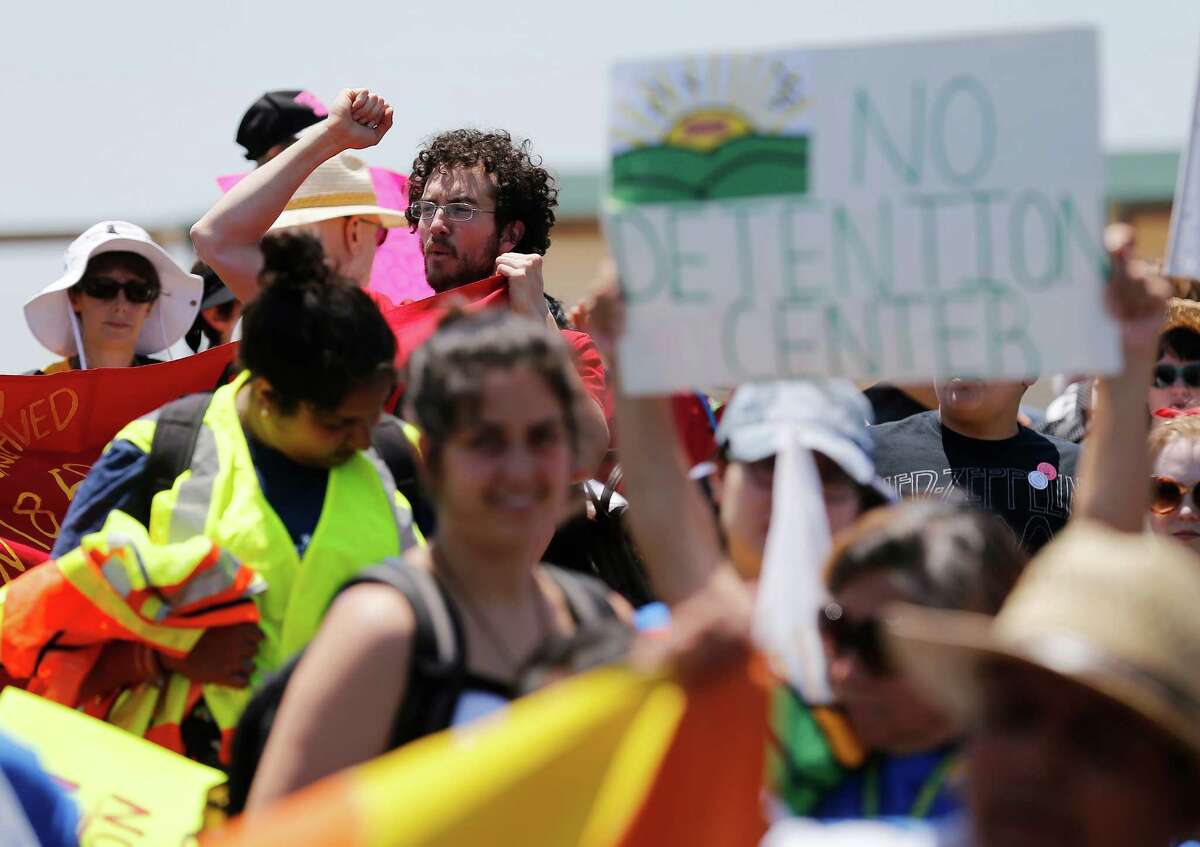 A young man who did not want to be identified joins hundreds during the immigration detention march and protest in Dilley, Texas on Saturday, May 2, 2015. (Kin Man Hui/San Antonio Express-News)