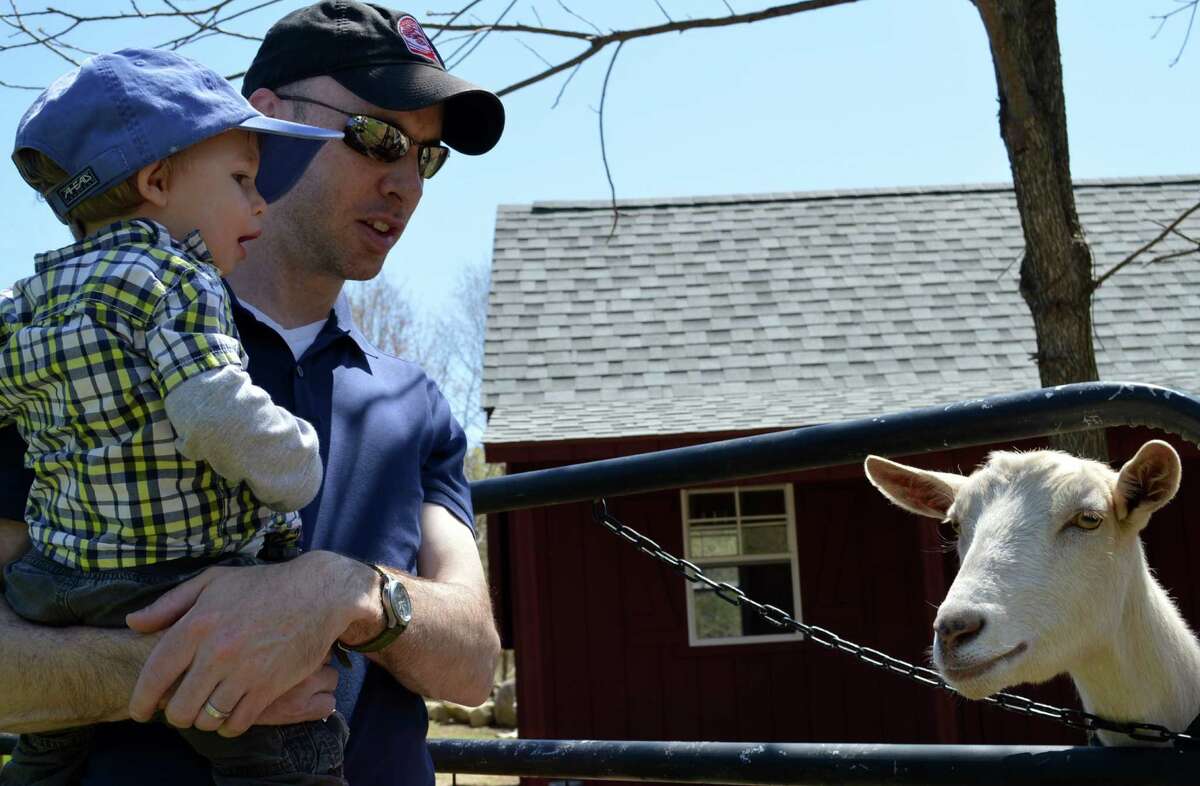 Matt Smith of Westport and son, Alex, 15 months, meet Daisy the goat during Wakeman Town Farm's GreenDay celebration.