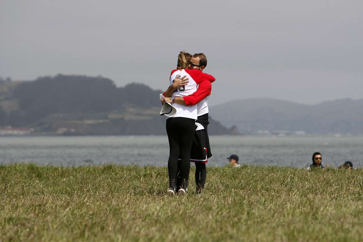 Marc Stiglitz and his wife, Kim Stiglitz, of San Francisco embrace near the finish of the 10th Annual AVM Awareness Walk hosted by the Aneurysm and AVM Foundation at Crissy Field in San Francisco on Sunday, May 4, 2015. Marc Stiglitz (44) suffered a congenital AVM rupture in 2011, and is still recovering. AVM is an arterial brain condition that can cause devastating hemorrhages and other symptoms.