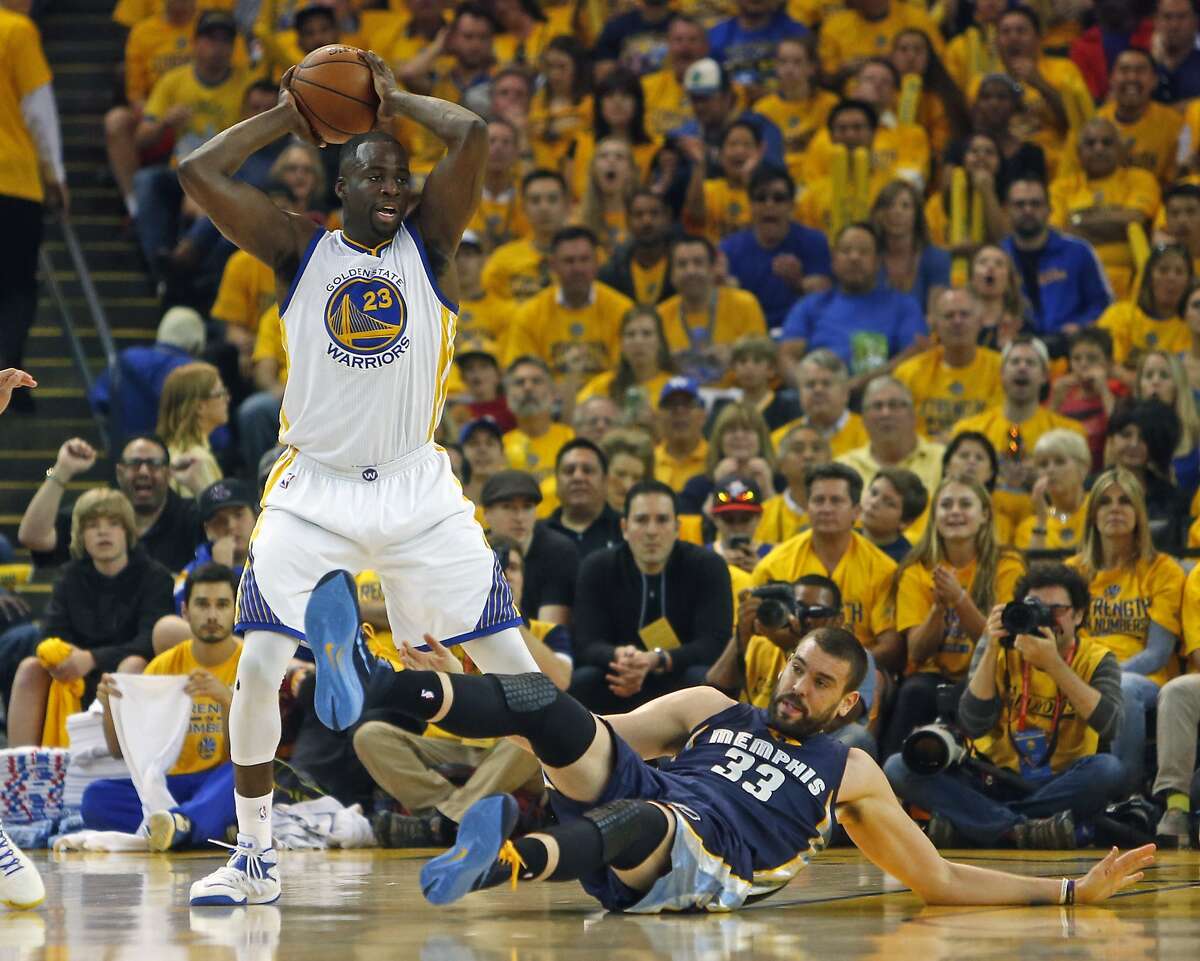 Golden State Warriors' Draymond Green wins a battle for a loose ball against Memphis Grizzlies' Marc Gasol in 1st quarter during Warriors' 101-86 win in Game 1 of NBA Playoffs' Western Conference Semifinals in Oakland, Calif., on Sunday, May 3, 2015.