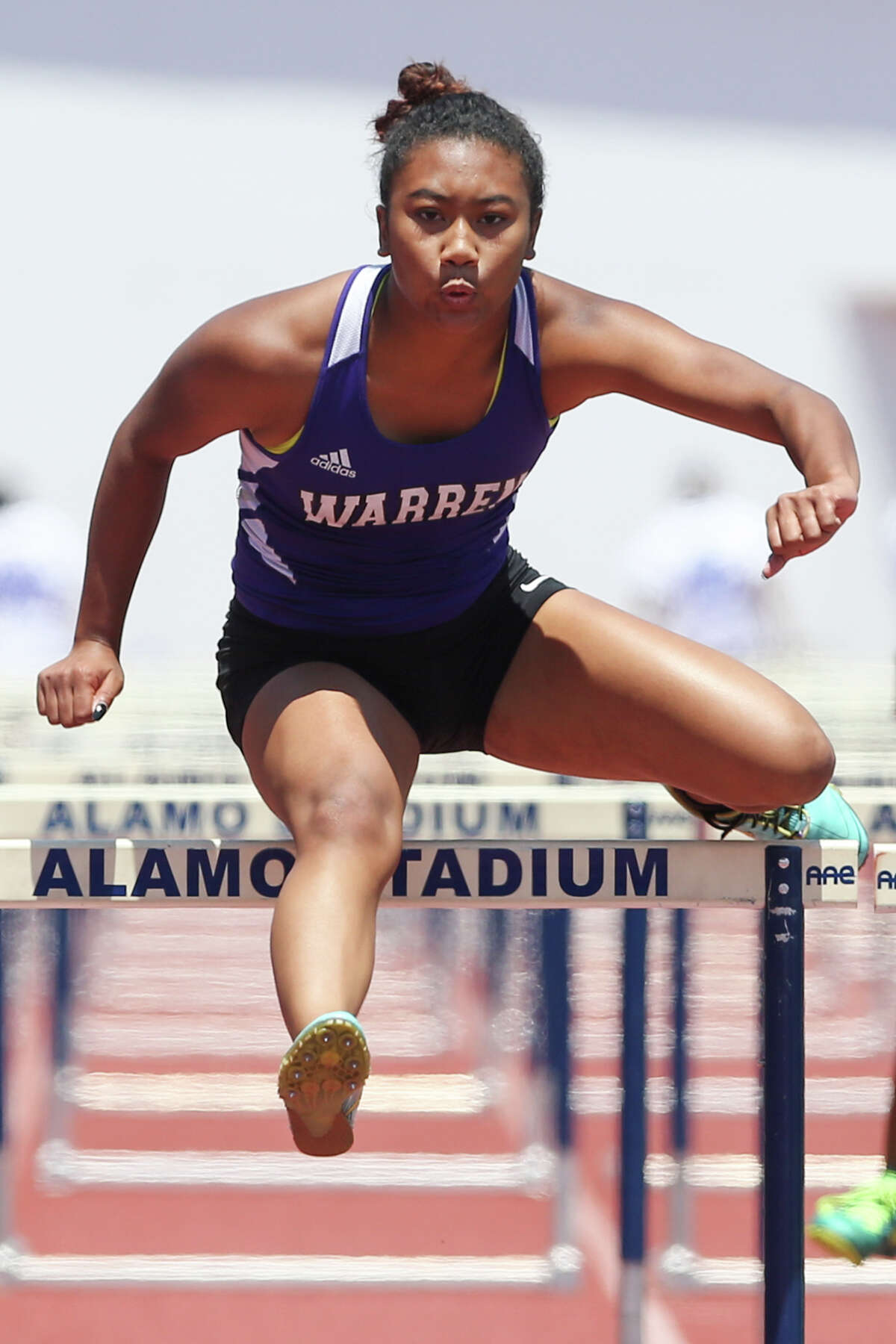 Warren's Jerica Love clears the final hurdle of the 6A 100-meter hurdles during the Region IV-5A and Region IV-6A Track and Field meet at Alamo Stadium on Saturday, May 2, 2015. Love won the event with a time of 14.84 seconds. MARVIN PFEIFFER/ mpfeiffer@express-news.net