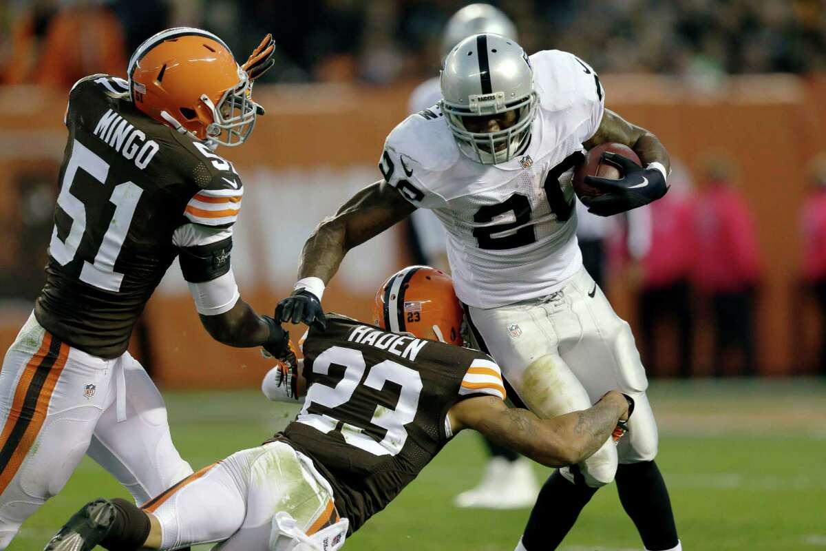 Oakland Raiders running back Darren McFadden is stopped for a loss by Cleveland Browns cornerback Joe Haden (23) and outside linebacker Barkevious Mingo (51) in the third quarter in Cleveland on Oct. 26, 2014.