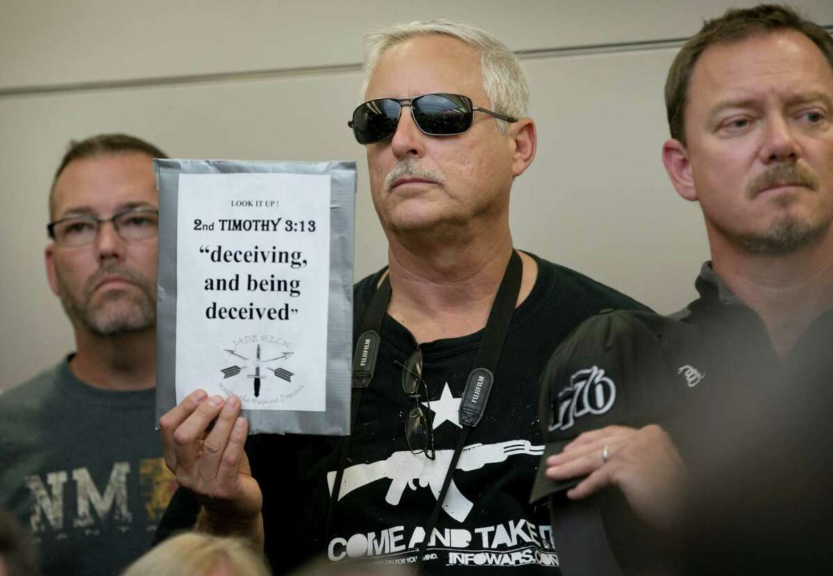 Bob Welch holds a sign Apr. 27 at a public hearing in Bastrop about the Jade Helm 15 military training exercise﻿.﻿ Gov. Greg Abbott last week ordered the Texas State Guard to monitor the exercise.