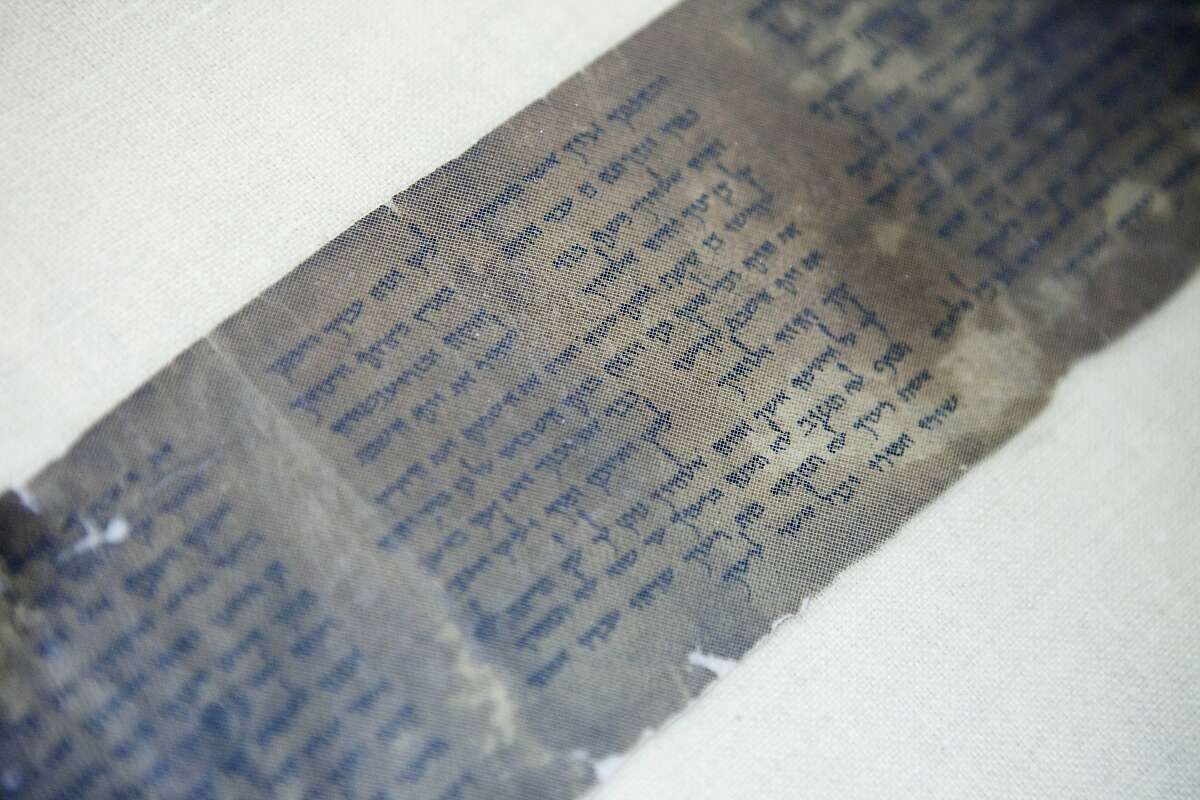 FILE - This Friday, May 10, 2013 file photo shows the world's oldest complete copy of the Ten Commandments, written on one of the Dead Sea Scrolls in Jerusalem. The manuscript is on rare display at Israel's national museum in an exhibit of objects from pivotal moments in the history of civilization.