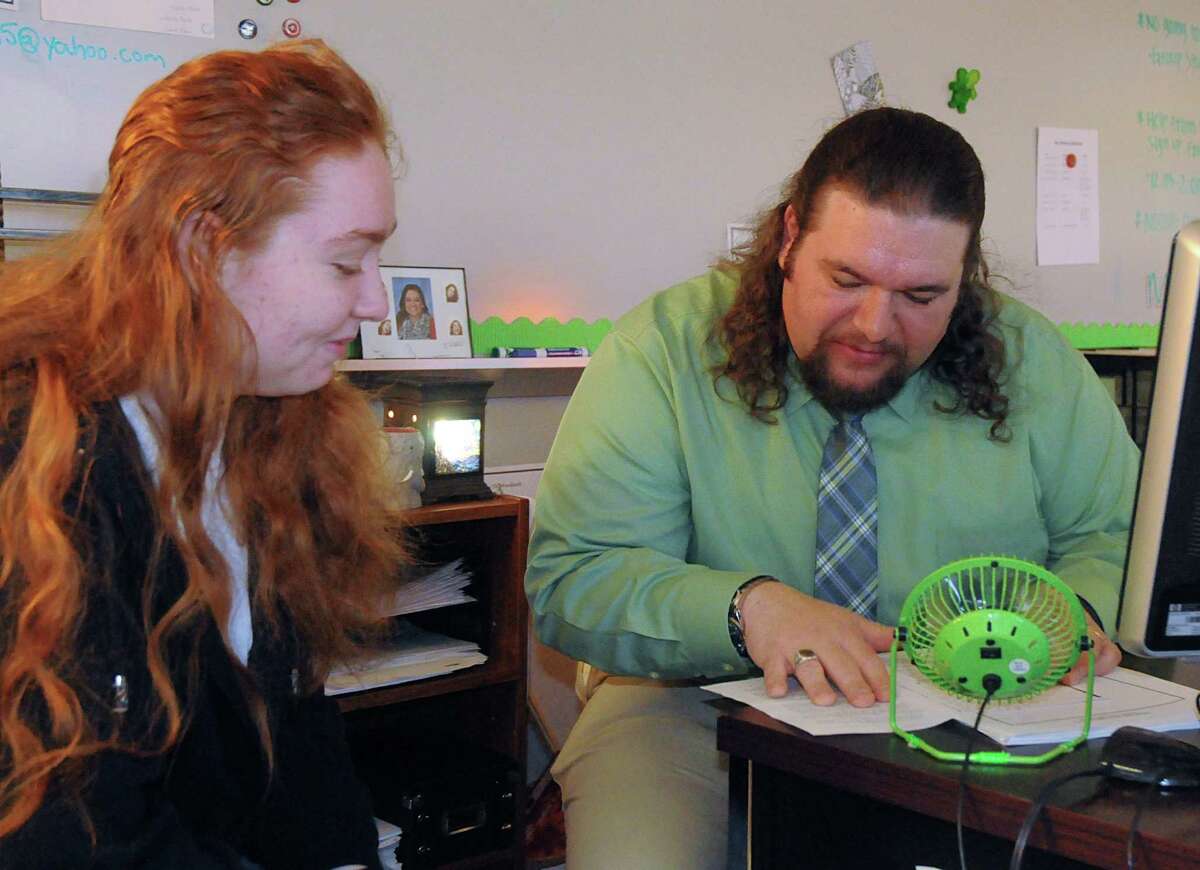 Teacher Daniel Rankins and student 11th grader Sarah Chisum, of The Woodlands, discuss a school project Chisum wrote at iSchool High Montgomery-The Woodlands, 3232College Park Drive in The Woodlands, on the Lone Star College Campus, greets a visitor. Photograph by David Hopper
