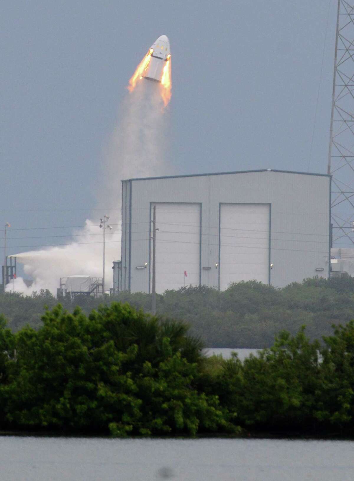 A SpaceX Dragon mock-up capsule blasts into the air, Wednesday, May 6, 2015 during a test flight in Cape Canaveral, Fla. The unmanned flight was testing a new, super-streamlined launch escape system for astronauts. The California-based company led by billionaire Elon Musk aims to launch U.S. astronauts to the International Space Station as early as 2017. (Craig Bailey/Florida Today via AP) NO SALES, MAGS OUT