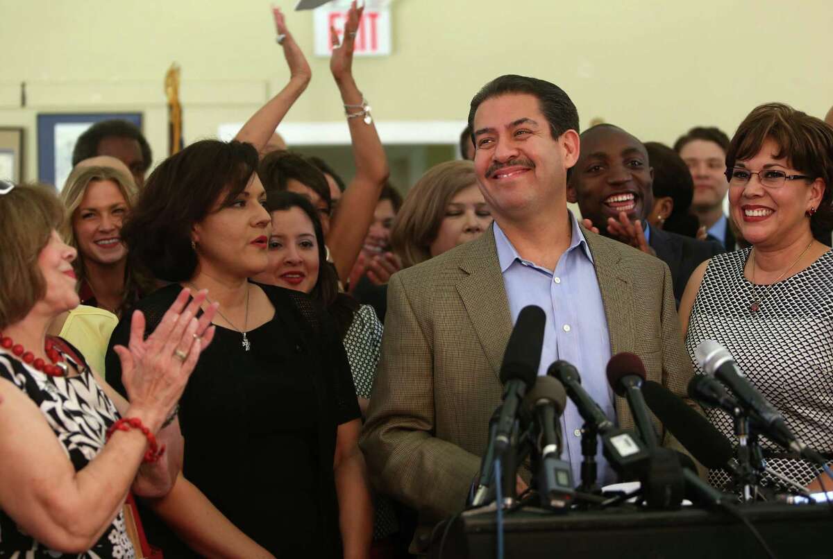Supporters applaud Sheriff Adrian Garcia and his wife, Monica, right, as he announces his bid for mayor.