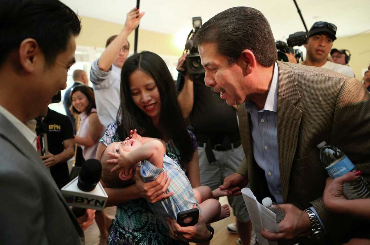 Mayoral hopeful Adrian Garcia greets Julie Walter and her son after he announces his candidacy Wednesday.