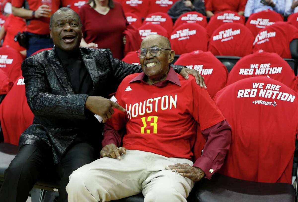 It was a big night for 100-year-old Wilbert Jackson, who thought he was going to dinner and instead was treated to his first Rockets game, complete with a courtside seat and visits from Calvin Murphy, left, and James Harden.
