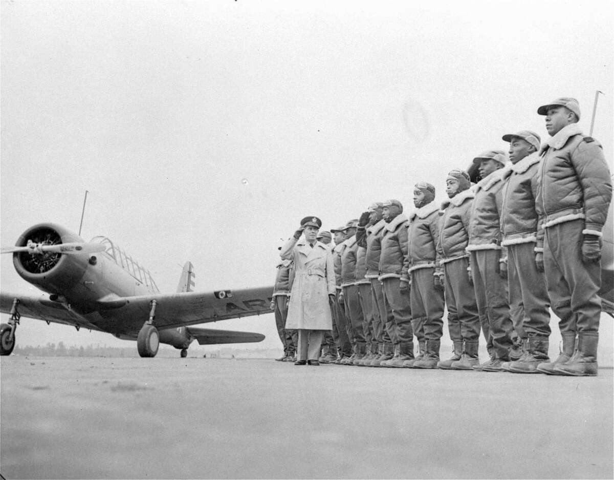 ** FILE ** In this Jan. 23, 1942 black-and-white file photo, Major James A. Ellison, left, returns the salute of Mac Ross of Dayton, Ohio, as he inspects the cadets at the Basic and Advanced Flying School for Negro Air Corps Cadets at the Tuskegee Institute in Tuskegee, Ala. Sixty years after President Truman desegregated the military, senior black officers are still rare, particularly among the highest ranks. (AP Photo/U.S. Army Signal Corps, File)