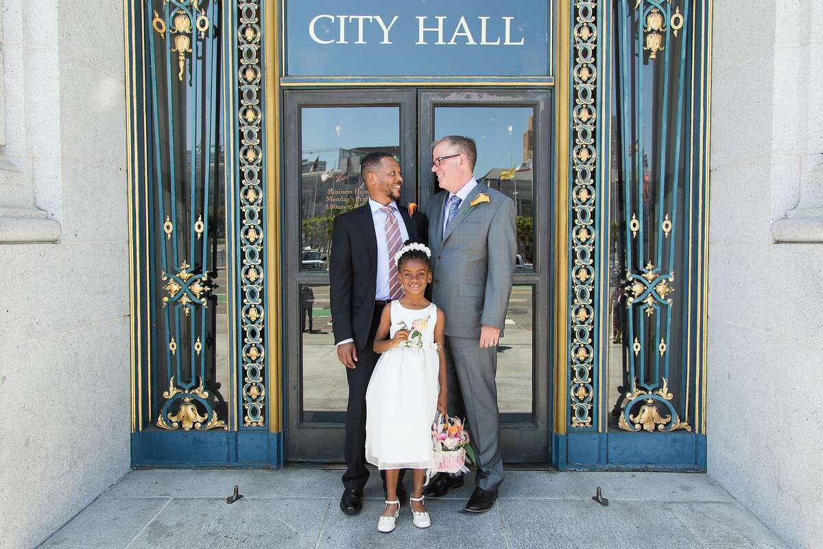 Juan Doubrechat, Delali Suggs-Akaffu and Bob Collins pose for a photo outside City Hall, Friday May 1, 2015, in San Francisco, CA.