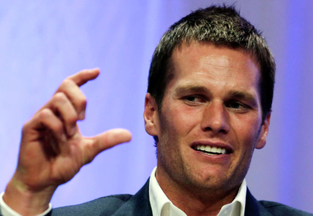New England Patriots quarterback Tom Brady gestures during an event at Salem State University in Salem, Mass., Thursday, May 7, 2015. An NFL investigation has found that New England Patriots employees likely deflated footballs and that quarterback Tom Brady was "at least generally aware" of the rules violations. The 243-page report released Wednesday, May 6, 2015, said league investigators found no evidence that coach Bill Belichick and team management knew of the practice. (AP Photo/Charles Krupa, Pool)
