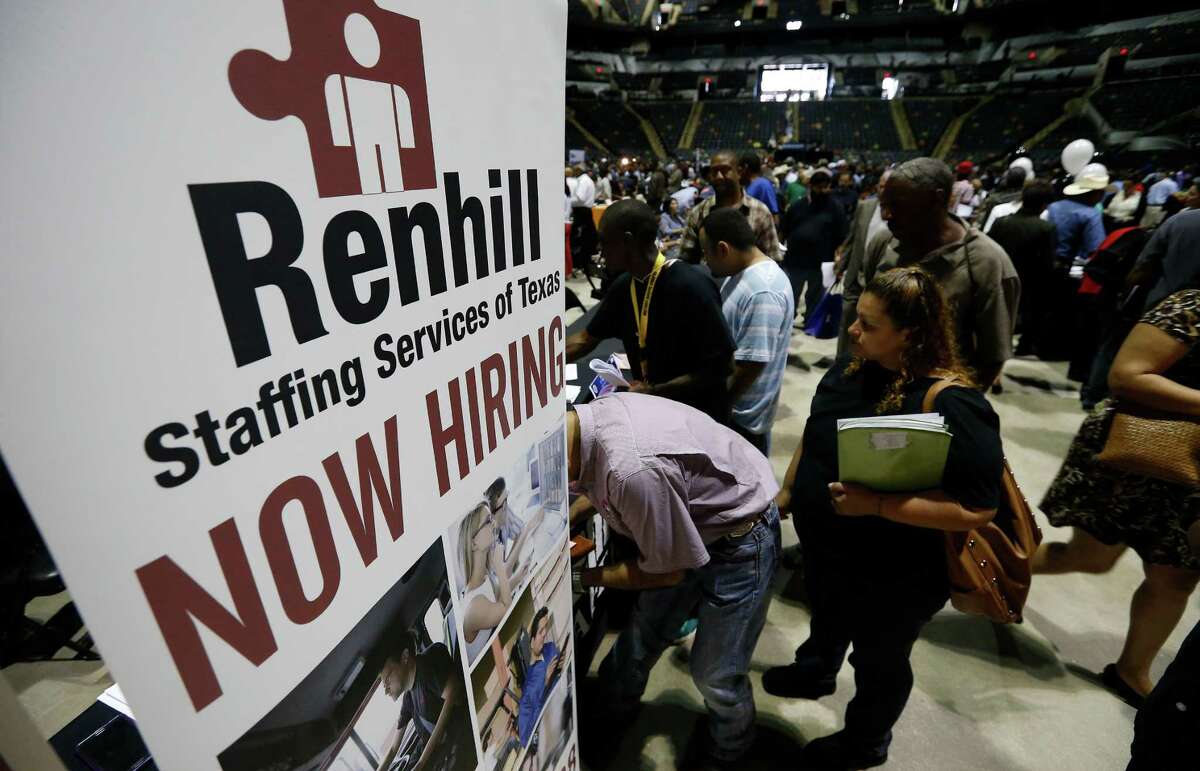 A small crowd waits to talk with staff at Renhill Staffing seeking work at the second chance job fair hosted by Bexar County Commissioner, Precinct 4 Tommy Calvert at the AT&T Center on Thursday, May 7, 2015. About 70 exhibitors and about 1,000 applicants were present at the three-hour long event.