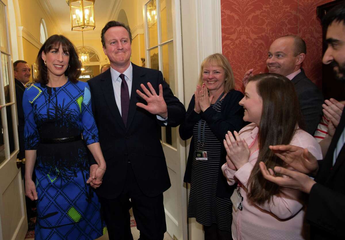 Prime Minister David Cameron and wife Samantha Cameron are applauded by staff upon entering No. 10 Downing St.
