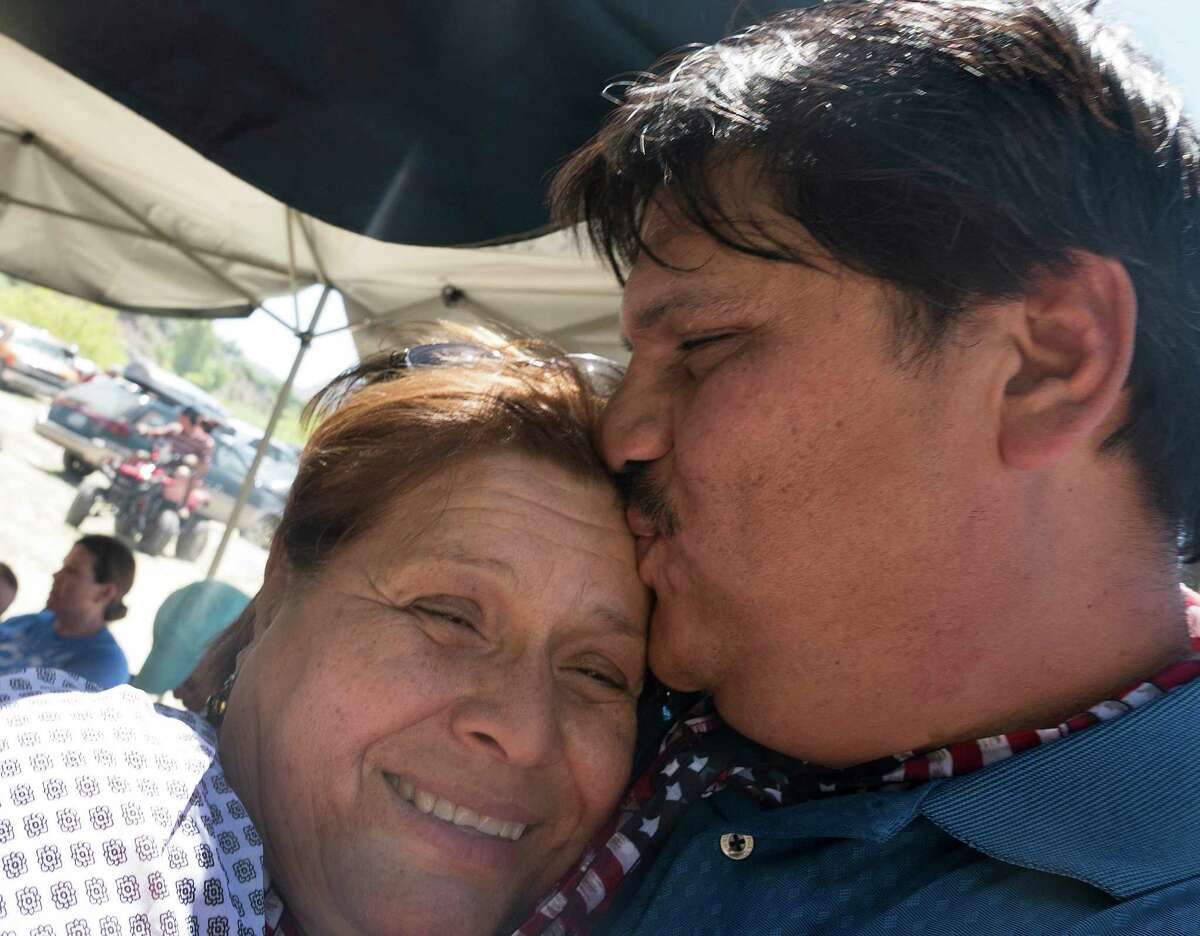 Yolanda Gonzalez, who was deported from the United States and had not seen her son, Anibal Pando, who lives in Pecos, Texas, in 11 years, gets a kiss from him after their reunion at the Voices From Both Sides festival held on the Rio Grande at Lajitas, Texas, on Saturday, May 9, 2015. Many people from Mexico and the United States gathered and in some cases reunited with family members that they have not seen for years because of the border.