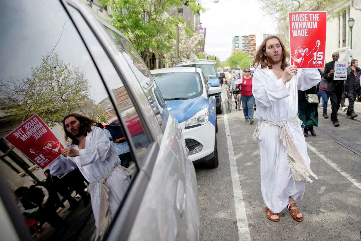Mike Grant also known as "Philly Jesus" marches in May Day demonstration calling for a raise of the minimum wages to $15 an hour Friday on May 1 at a McDonald's restaurant in Philadelphia..Rep. Trey Martinez Fischer is proposing a bump to $10.10 an hour in Texas through a constitutional amendment on which voters would decide.