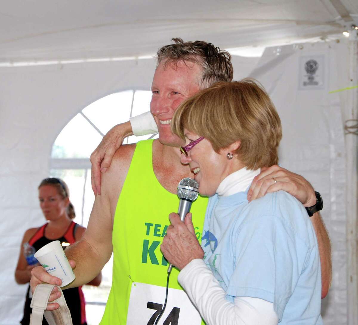 The Jim Fixx Award goes to noneother than his son, John Fixx, which Mary Green presented. The Jim Fixx Award, in honor of the author and running guru, is given to the individual who collects the most in contributions to the beneficiaries of the race. John Fixx raised over $2500 running to the top of the Empire State Building, benefitting the Bennet Cancer Center.