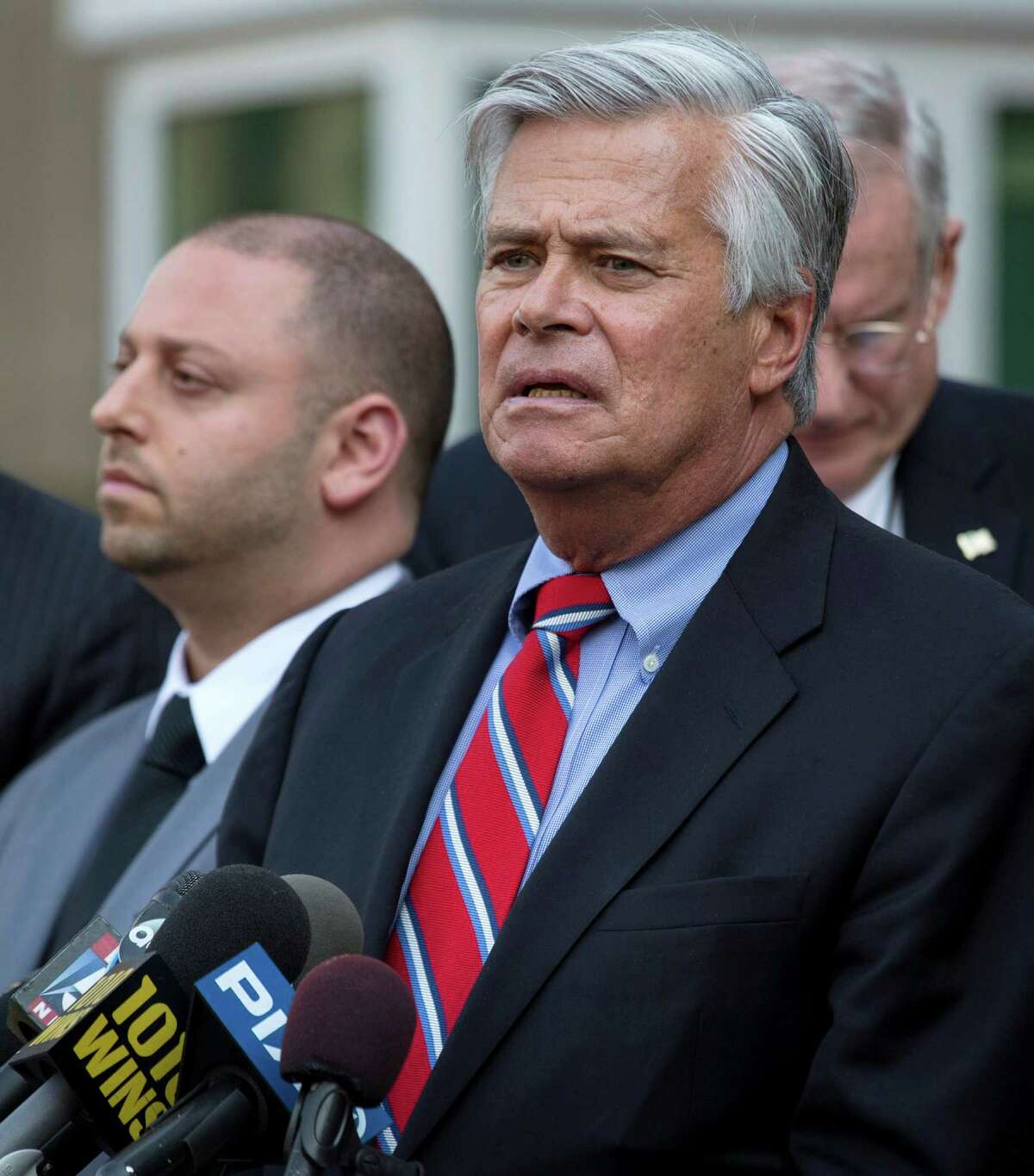 FILE- In this May 4, 2015 file photo, New York Senate Majority Leader Dean Skelos, right, speaks alongside his son Adam after their arraignment on federal charges including extortion and soliciting bribes. Dean Skelos, who was born, raised and still lives in Rockville Centre, said that despite growing pressure for him to resign, he is getting strong support from his Long Island neighbors. (AP Photo/Craig Ruttle, File) ORG XMIT: NYR401