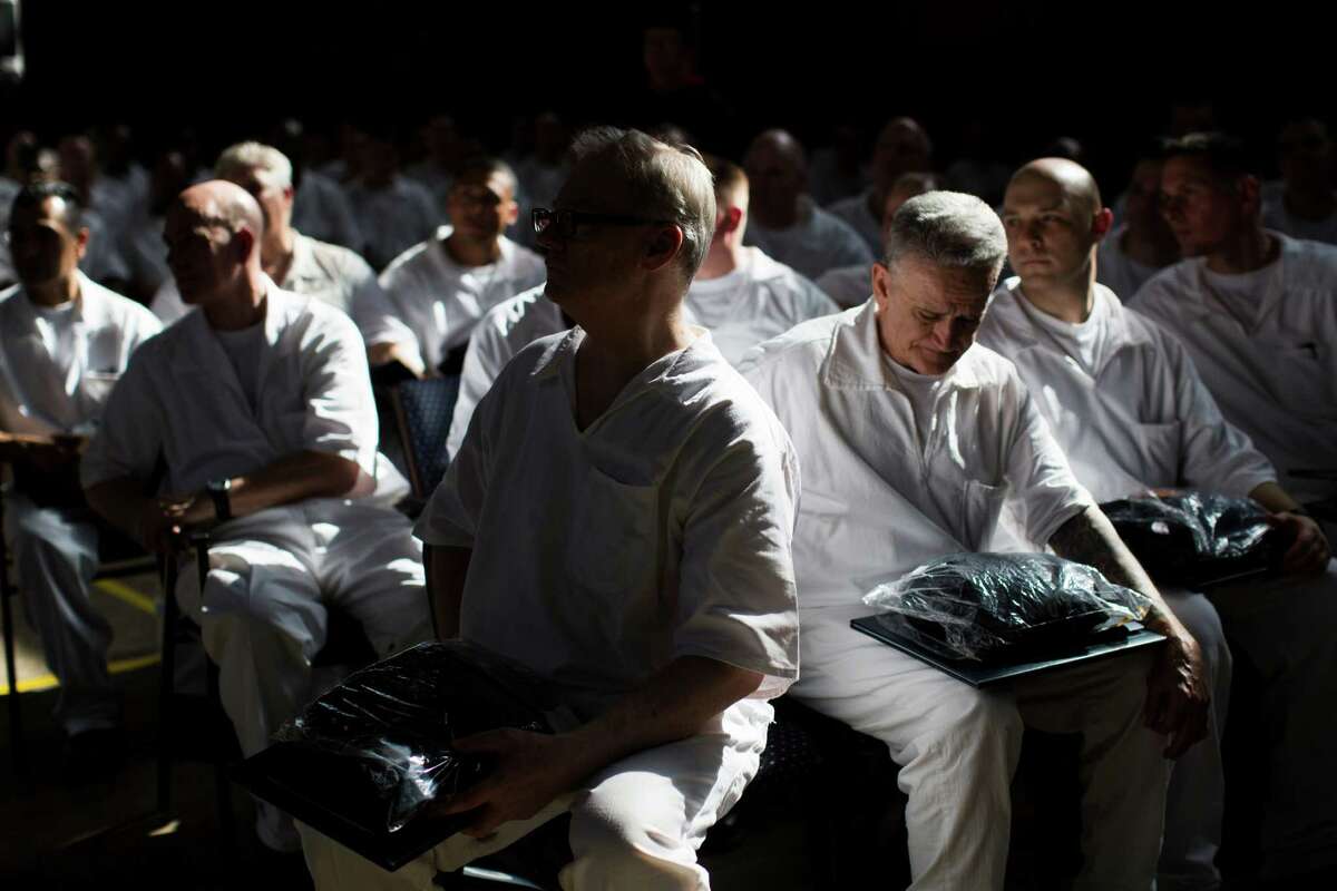 Darrington Unit inmates wait for their chance to meet with their families after their commencement ceremony at the prison, Saturday, May 9, 2015, in Rosharon. 33 Darrington Unit inmates received a bachelor degrees in biblical studies and one candidate received a masters in divinity.