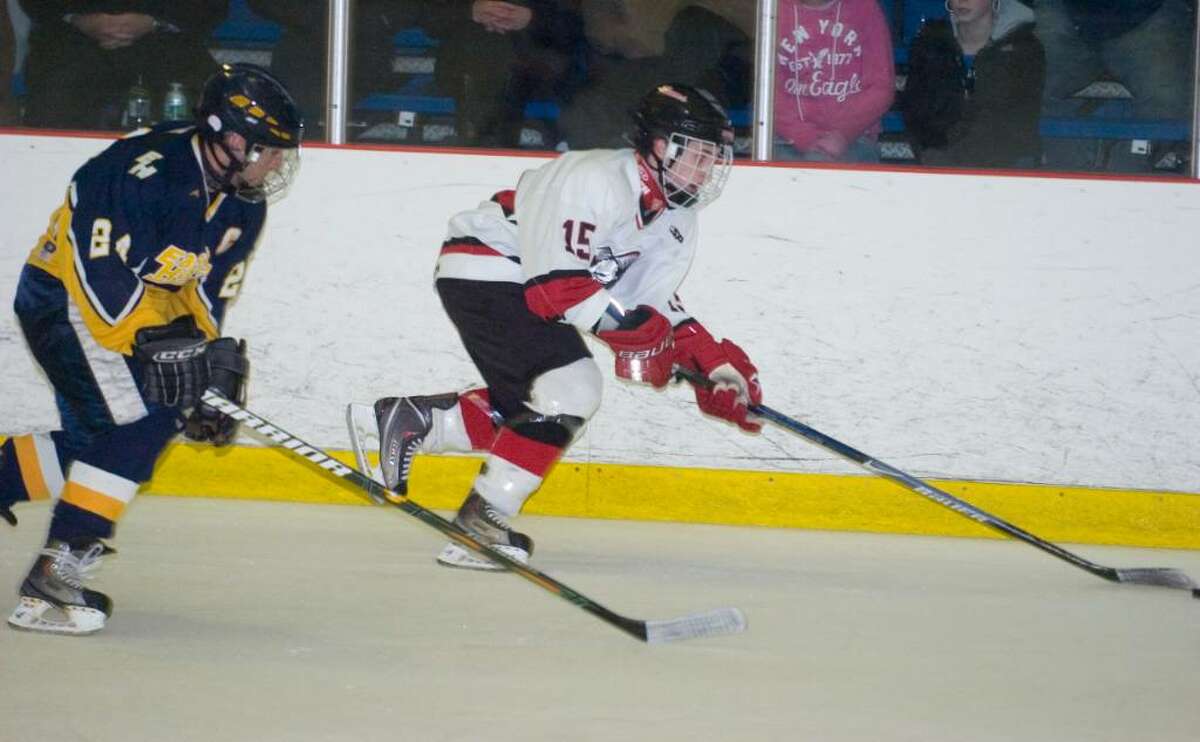 New Canaan's Dylan Hart, right, and East Haven's Lou Pane, left, during the first round of the CIAC Division I ice hockey tournament at the Darien Ice Rink in Darien, Conn. on Wednesday, March 10, 2010.