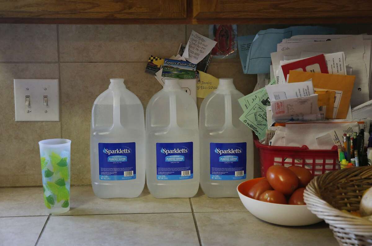 Bottled water used that can be used for cooking and brushing teeth sits on the kitchen counter at Yolanda Serrato's home April 13, 2015 in Porterville, Calif. Serrato's well ran dry while she was watering her lawn in the summer of 2014. Her family recently received a large tank that holds about two weeks worth of non-potable water. More than 500 wells have gone dry in East Porterville since the beginning of the drought four years ago. The Porterville Area Coordinating Council has provided homes that have run out of water with 300-gallon tanks and the city has been filling them while the county replaces the small tanks with larger 1,500-2,500 tanks as part of the county?•s household tank program. The larger tanks are filled every two weeks and the city has also been providing residents who sign up for the program with bottled water.