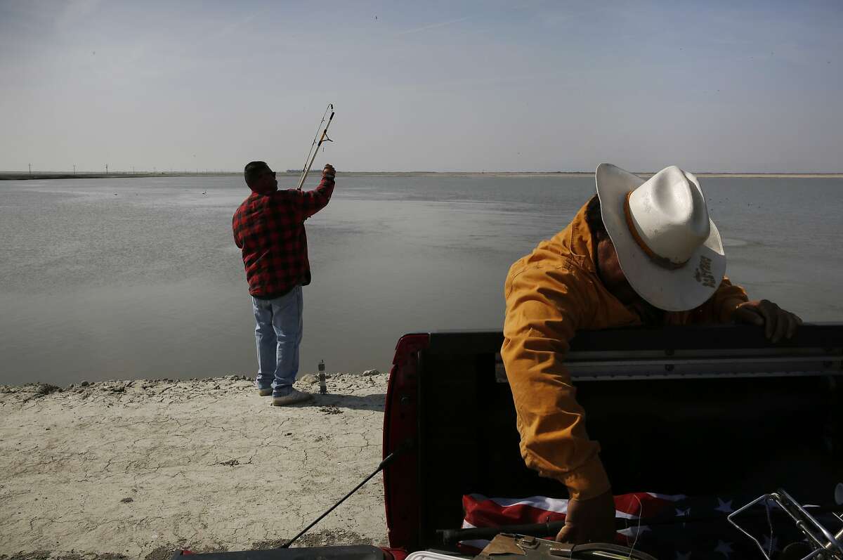Jessie Jimenez, 48, left, and Eugenio Pi–eiro, 51, fish at the South Wilbur Flood Area April 10, 2015 near Kings County, Calif. The reservoir is used for water storage by the Tulare Lake Basin Water Storage District. The body of water is situated in part of the San Joaquin Valley that used to contain the Tulare Lake, the largest freshwater lake in the western half of the continental United States. The lake was dried up by the year 1900 due to emerging agriculture in the region.