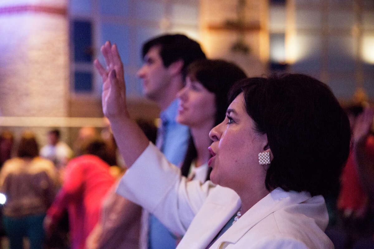 Mayoral candidate Leticia Van de Putte sings with her family during a service with 210 Church at Johnson High School in San Antonio, Texas on Sunday, May 10, 2015.