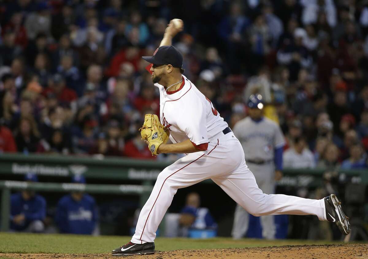 Boston Red Sox relief pitcher Edward Mujica delivers a pitch in the fourth inning of a baseball game against the Toronto Blue Jays, Tuesday, April 28, 2015, in Boston. (AP Photo/Steven Senne)