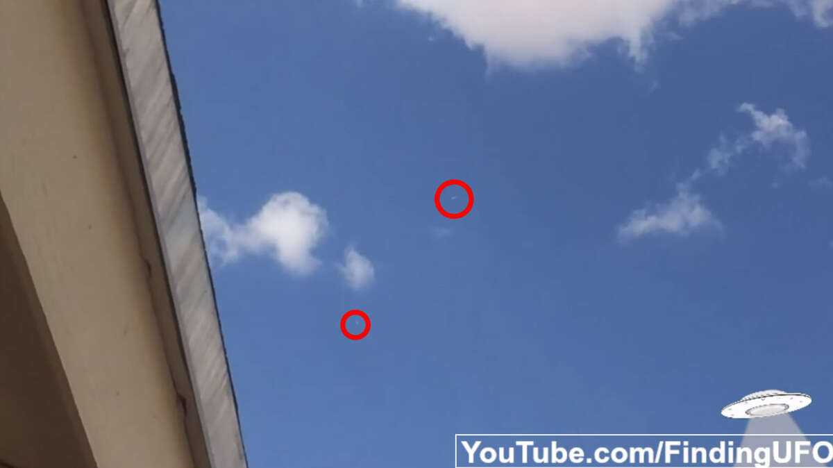 While an amateur videographer in El Paso looks on in amazement as two unidentified white objects flutter by high overhead, a third zooms by at speeds too fast to see by the naked eye. (ABOVE: The two objects.)