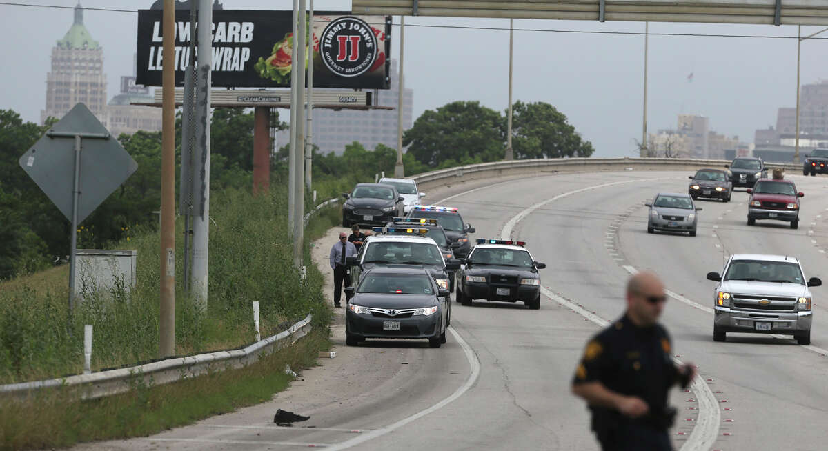 San Antonio police investigate a scene on the side of IH-37 near IH-10 where a deceased small baby was found inside of a piece of luggage about 10:30 a.m. Monday May 11, 2015.. Police spokesman Javier Salazar said a worker who was about to mow the area did an inspection of the area before mowing and opened the piece of luggage and contacted police.